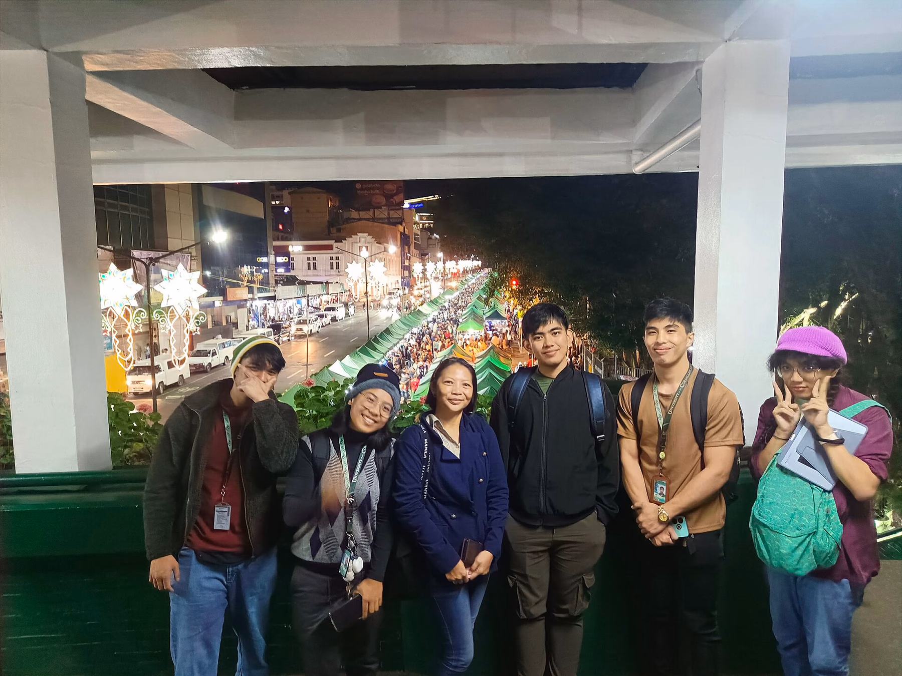 Visitors at an overlook with Harrison Road night market in the background