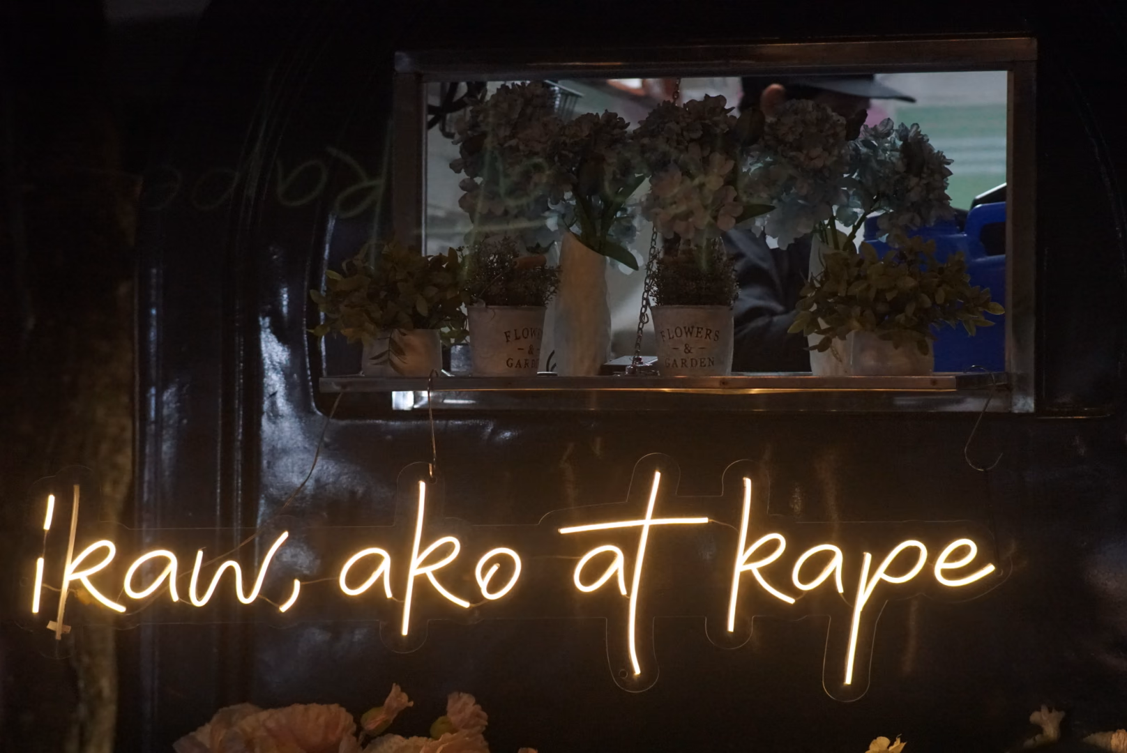 Illuminated café sign at the nearby Rose Garden night stalls
